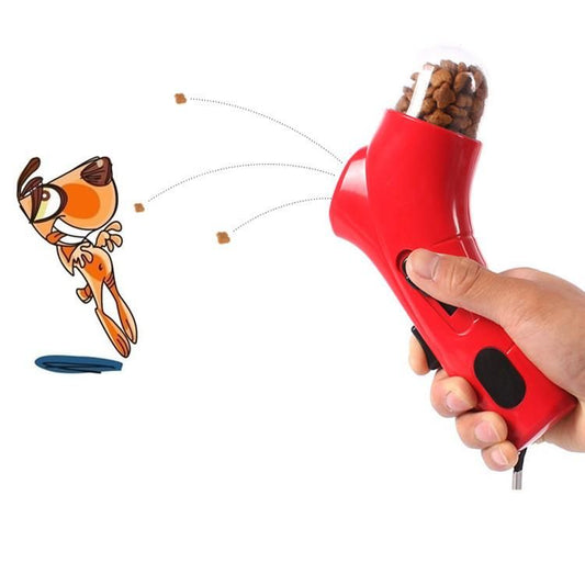 Red interactive pet treat toy launcher dispensing treats with animated dog catching them