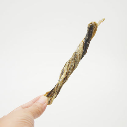Hand holding an American Pet Supplies codfish skin dog treats stick on a white background