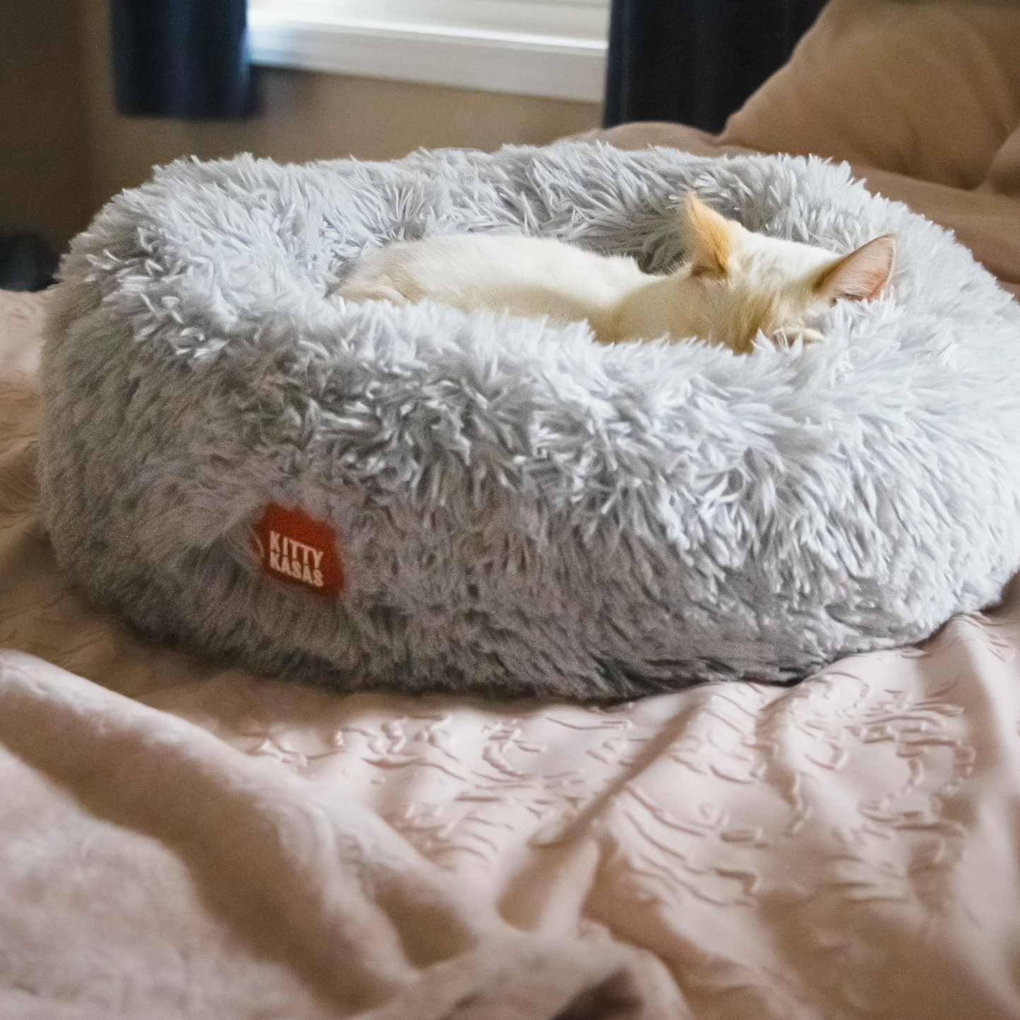 Cozy plush donut cat bed in soft gray with a comfy design for a relaxing pet experience