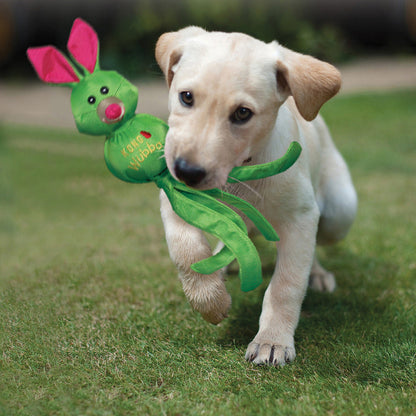 Labrador puppy playing with a Kong Wubba Friends Ballistic dog toy in a green bunny design