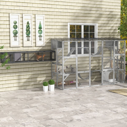 Outdoor large cat enclosure attached to house with multiple levels and ramps for pets