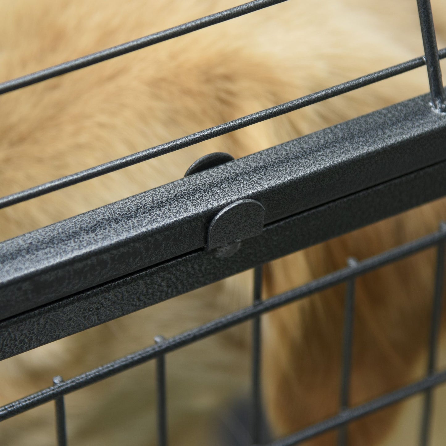 Close-up of a latch on a heavy duty dog crate with wheels showing sturdy metal construction