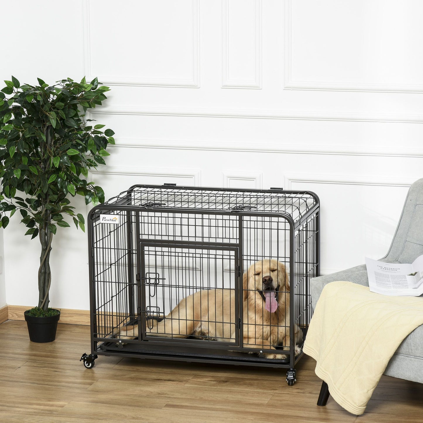 Heavy duty dog crate with wheels made of black metal holding a golden retriever inside