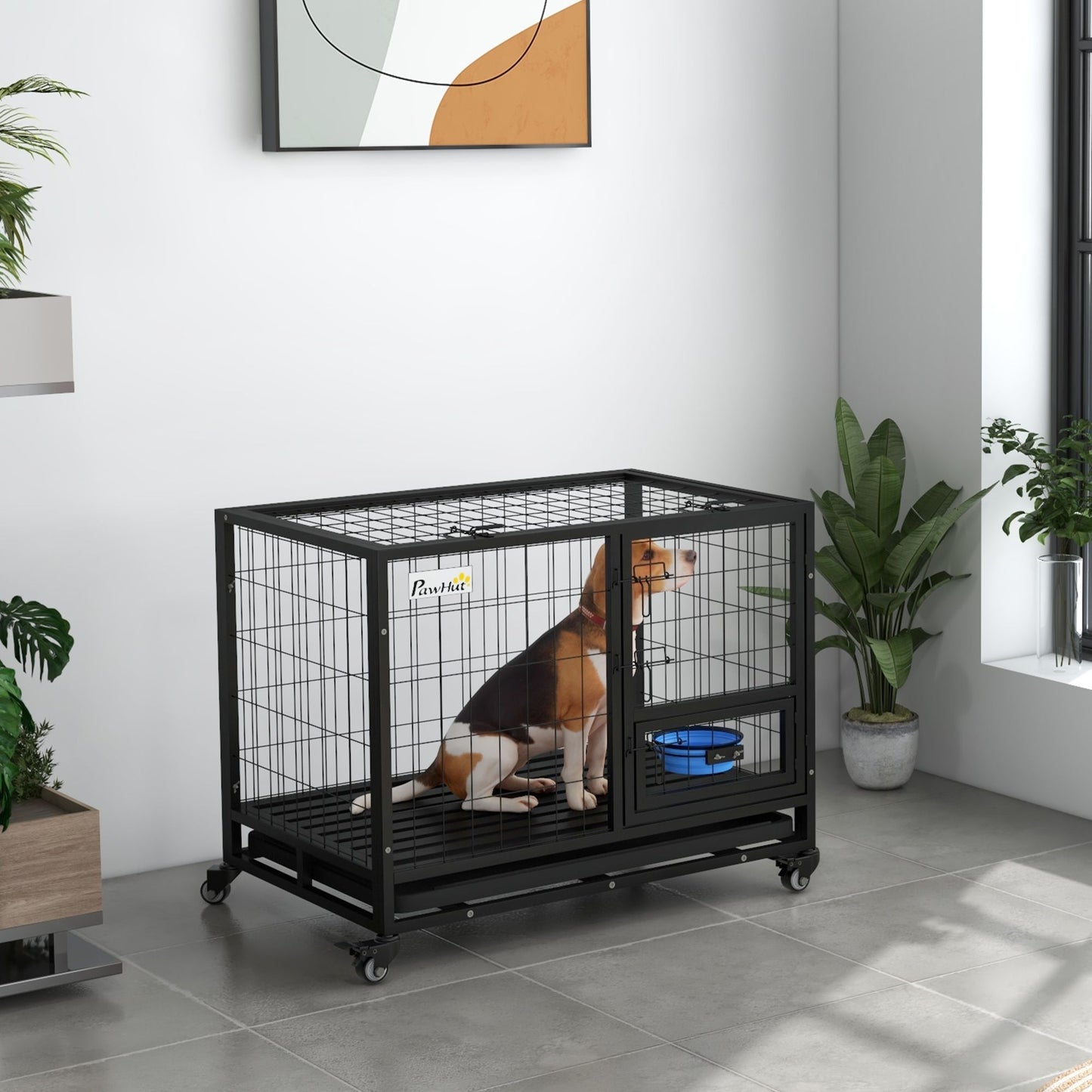 Heavy duty metal dog kennel with black frame and wheels containing a beagle inside with a blue bowl