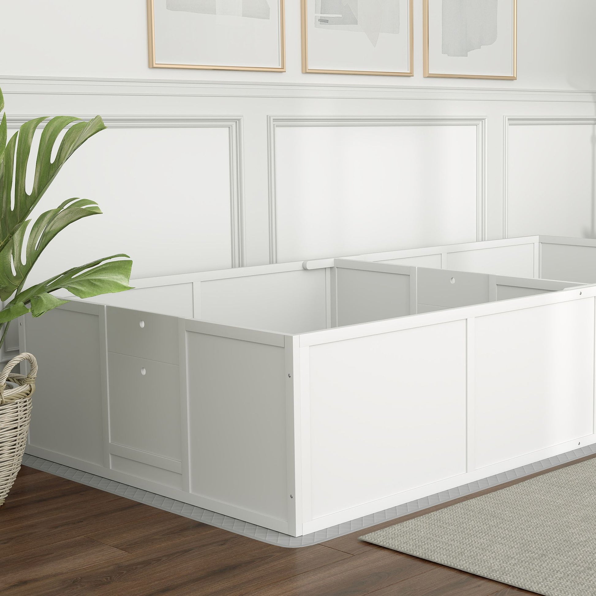 White wooden whelping box for puppies placed in a bright room with wood flooring and wall decor
