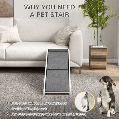 Grey pet ramp for dogs and cats placed in front of white sofa with dog sitting nearby