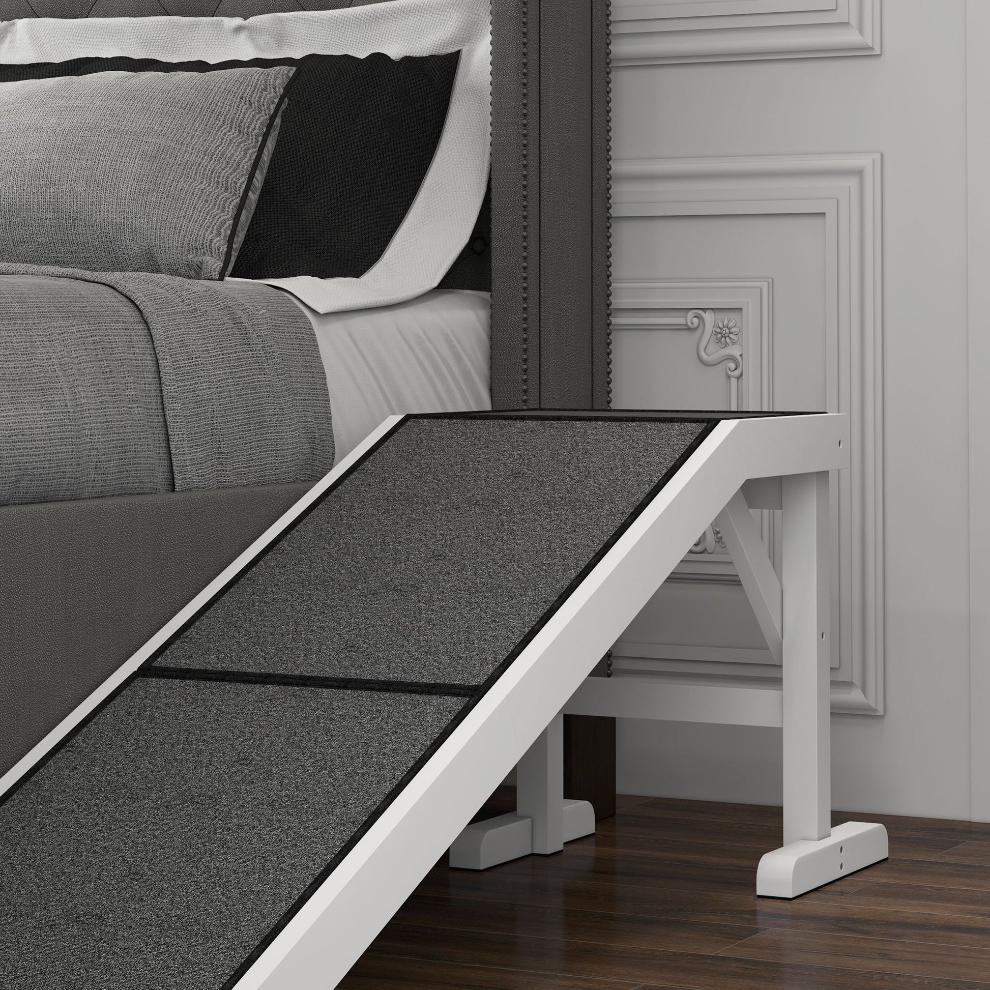 White and gray pet ramp for dogs and cats beside a gray bed on wood floor