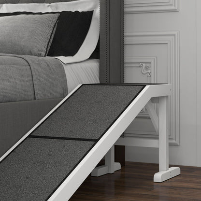 White and gray pet ramp for dogs and cats beside a gray bed on wood floor