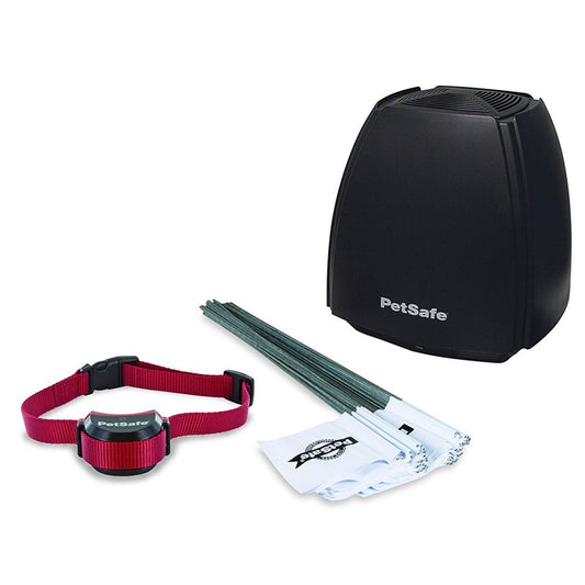 PetSafe wireless dog fence system with black transmitter, red collar receiver, and boundary flags