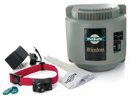 PetSafe wireless dog fence system with transmitter, red collar, charger, flags, and boundary flags for pet containment