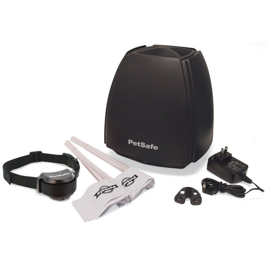 PetSafe wireless pet fence system with black receiver collar, transmitter, flags, and power adapter