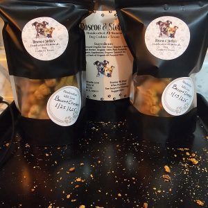 PawCounter natural dog treats in black packaging with visible treat pieces inside