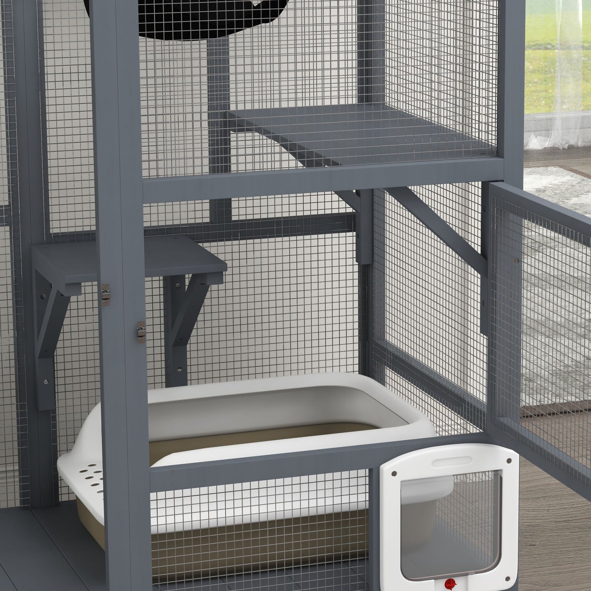 Gray indoor cat house on wheels with mesh sides and a removable white litter box inside
