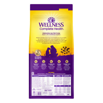 Wellness Complete Health dog food in a yellow and purple bag for optimal nutrition and health benefits